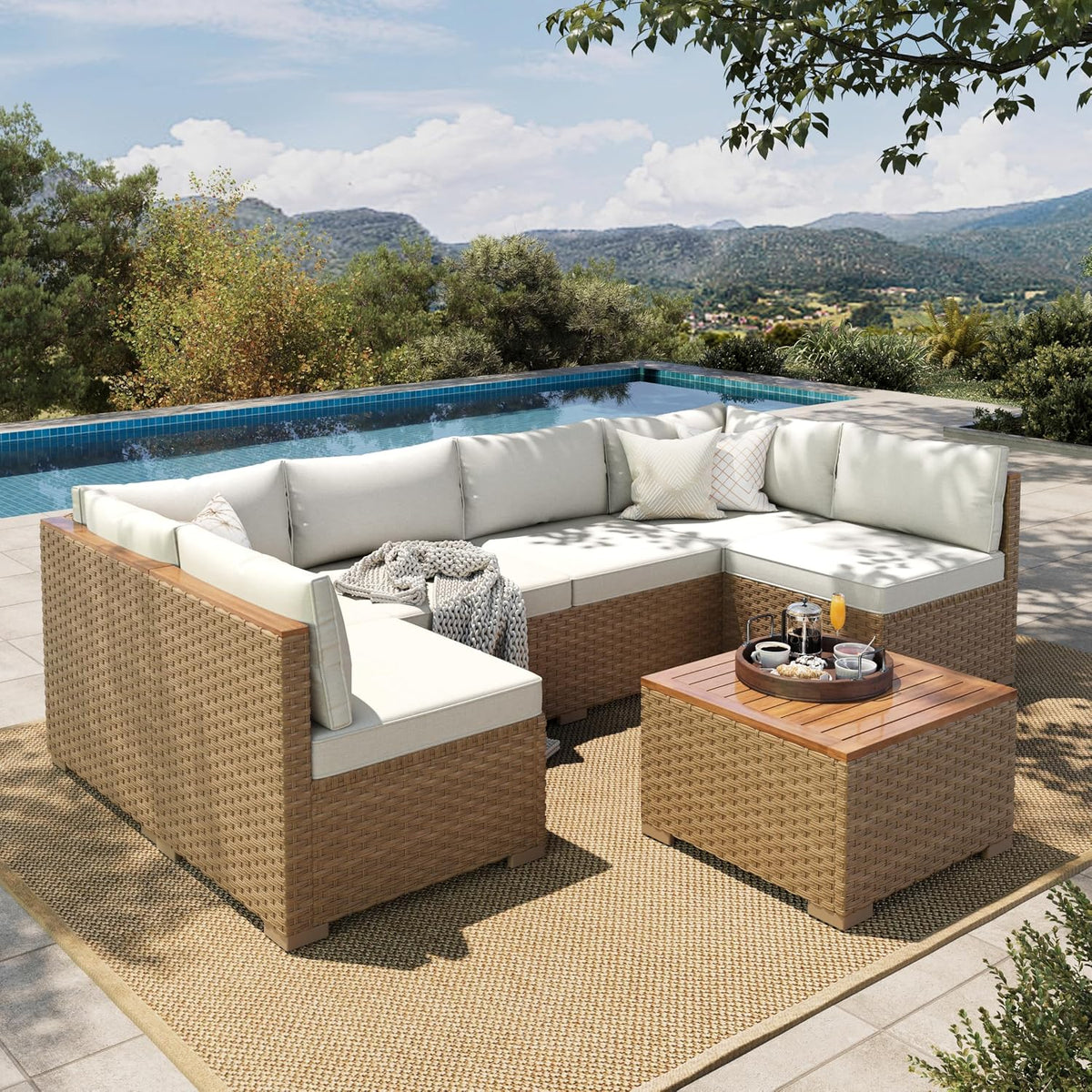 Outdoor scene showing a three-piece wicker sectional with light beige cushions arranged around a square wicker coffee table
