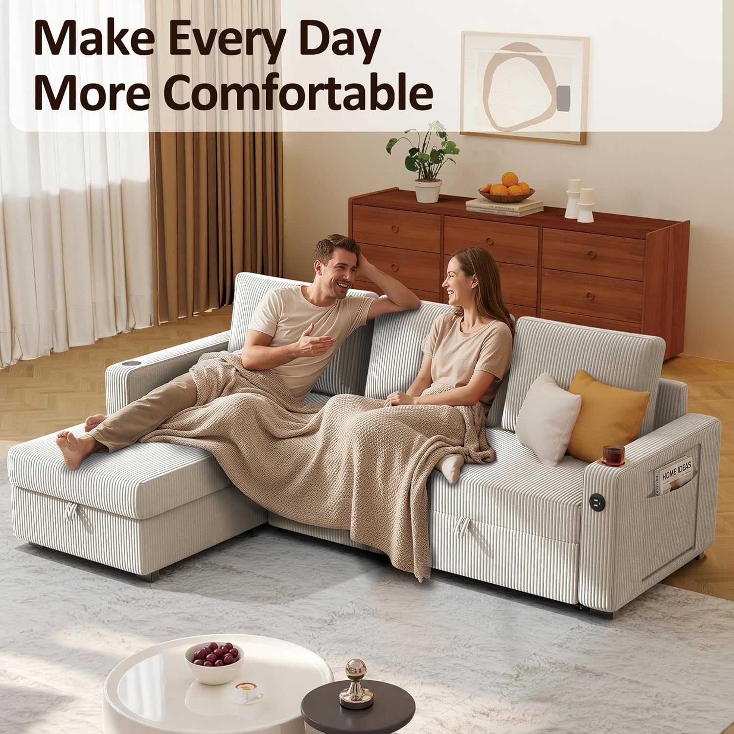 Two people lounging on a cream corduroy L-shaped sectional showing side pocket and USB port.