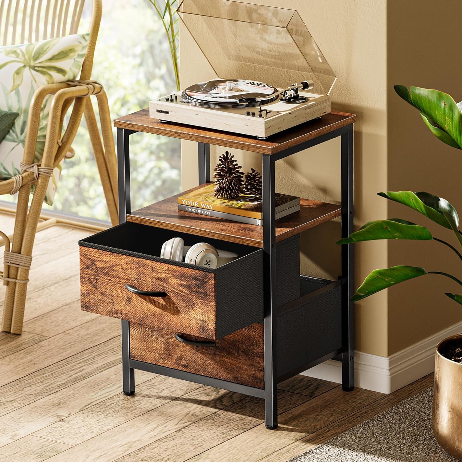 Single nightstand in room setting with top turntable and one fabric drawer open showing headphones inside