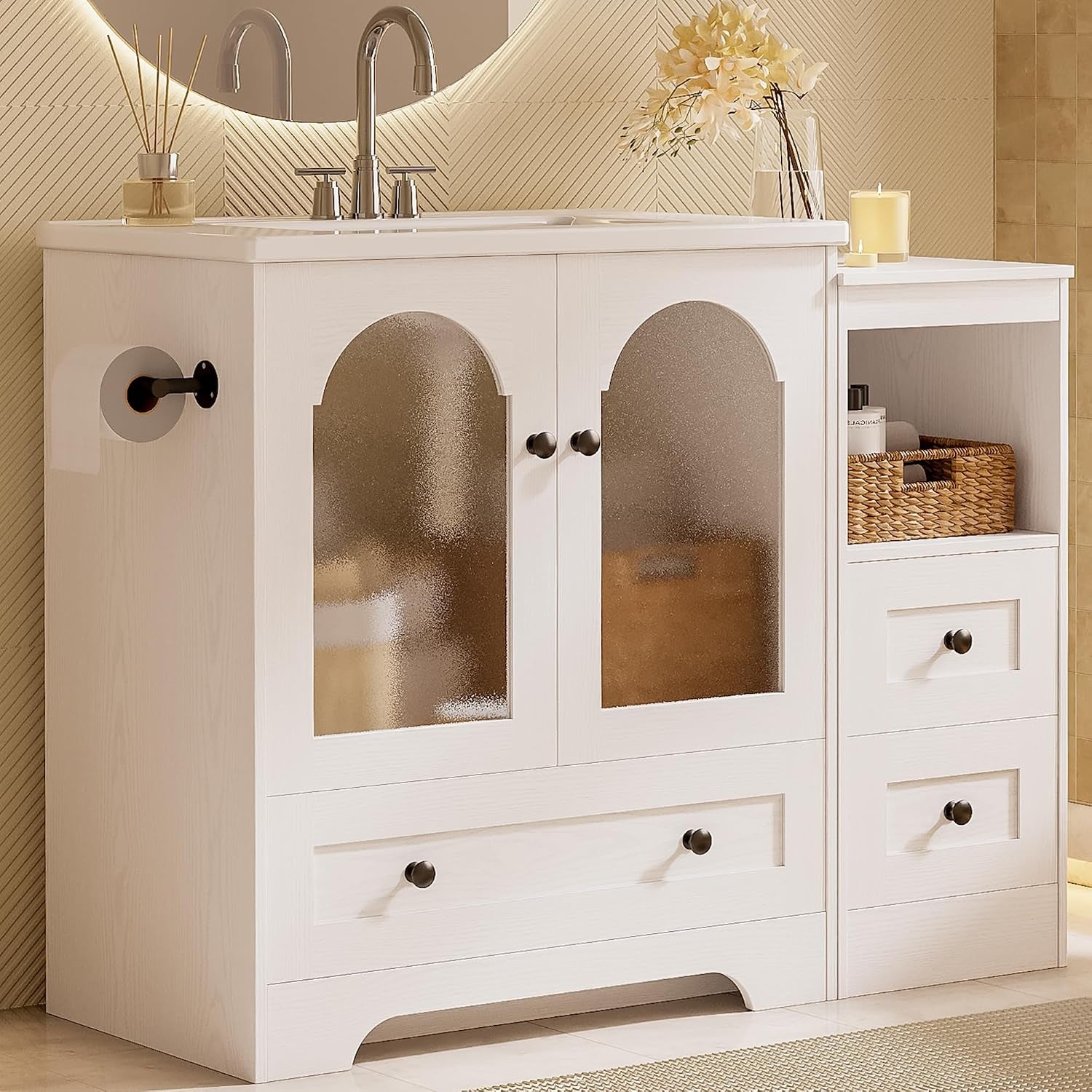 Angled close-up of the white vanity showing frosted arch doors, lower drawer and side open cubby with basket