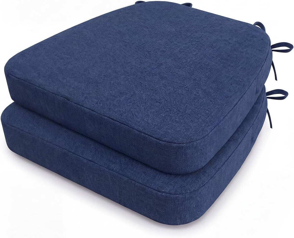 Pair of navy blue D-shaped seat cushions stacked, photographed from above to show textured cover and side ties