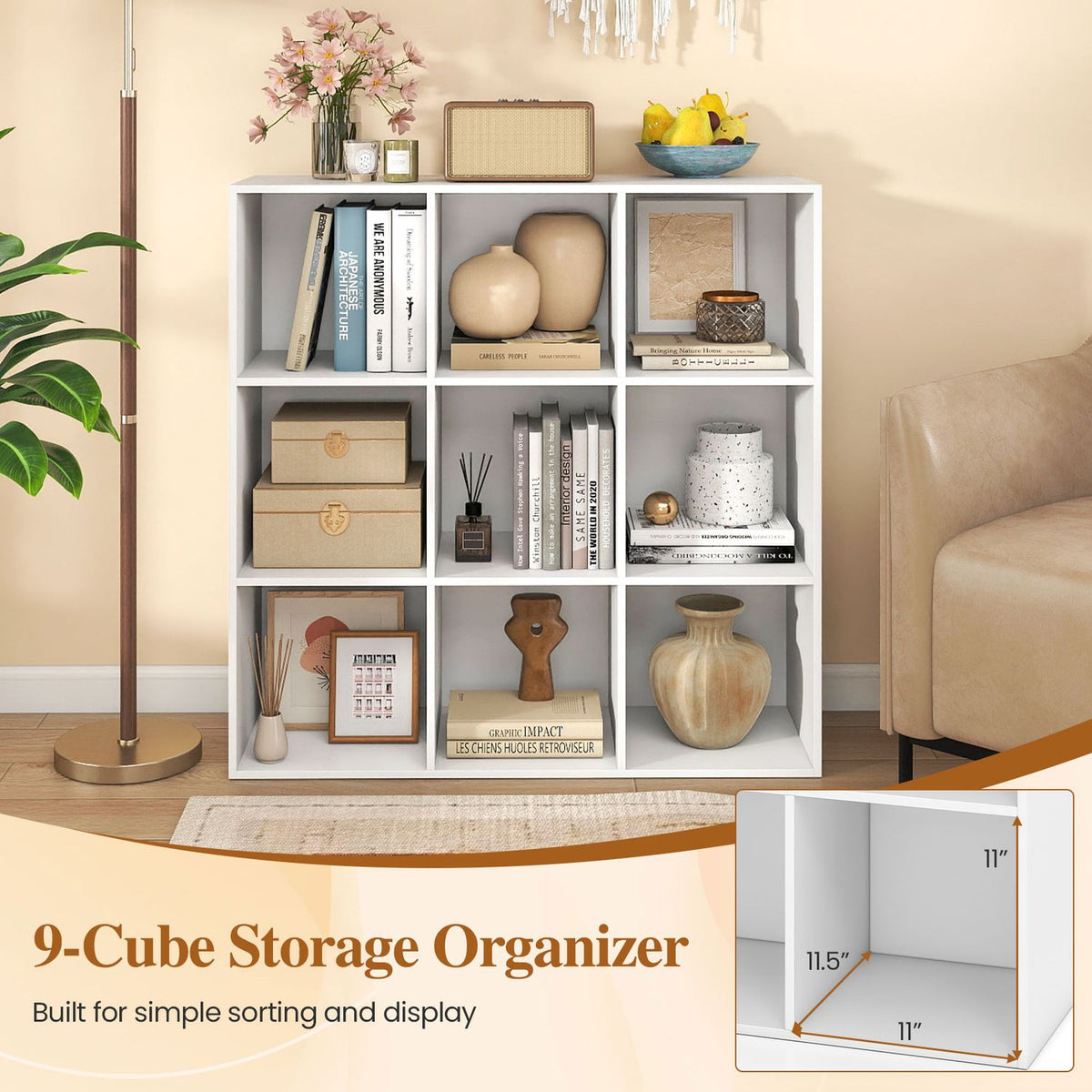 White nine-cube bookcase styled with books and decor beside a floor lamp and armchair.