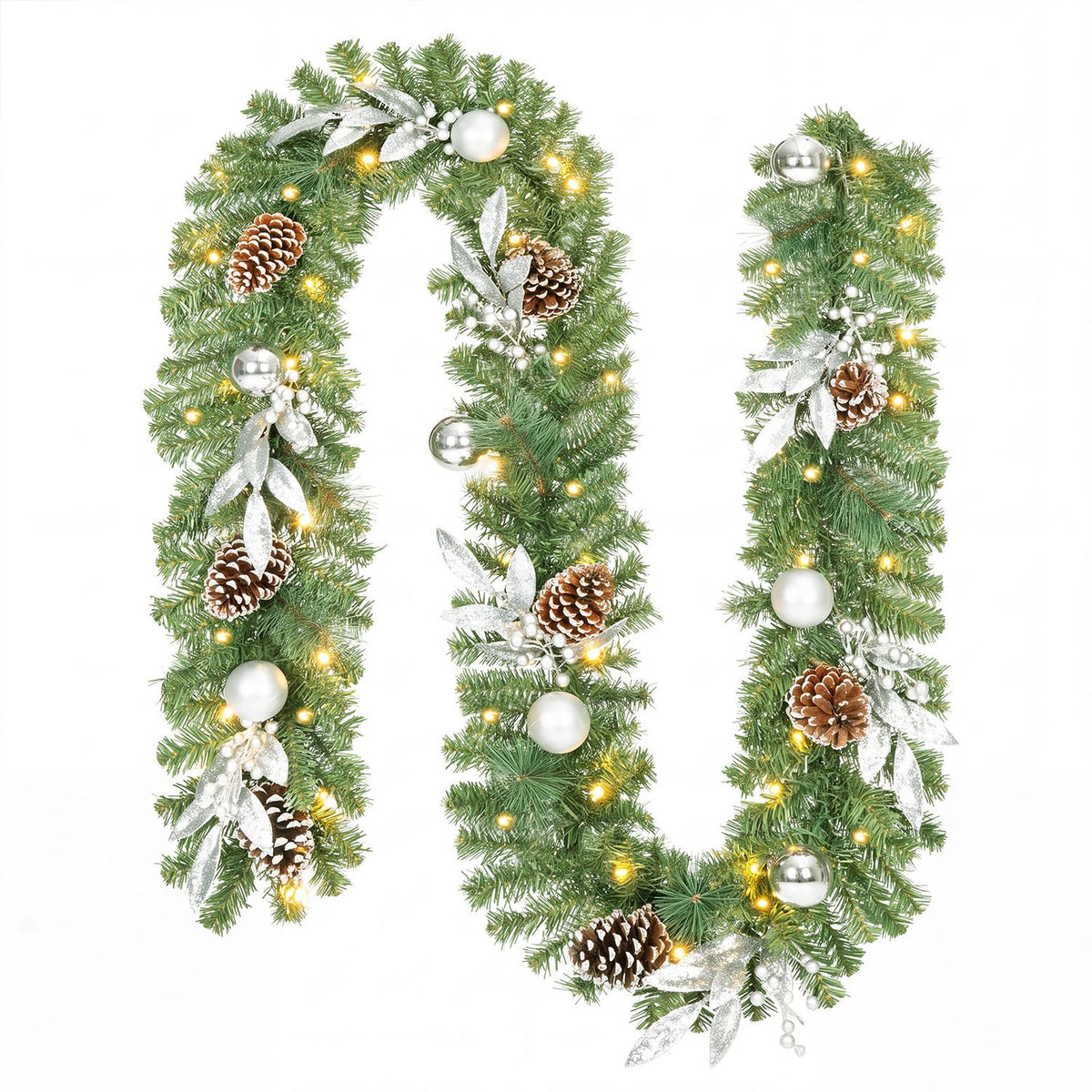 Green Christmas garland glowing with warm lights, pinecones, silver ornaments and white foliage.
