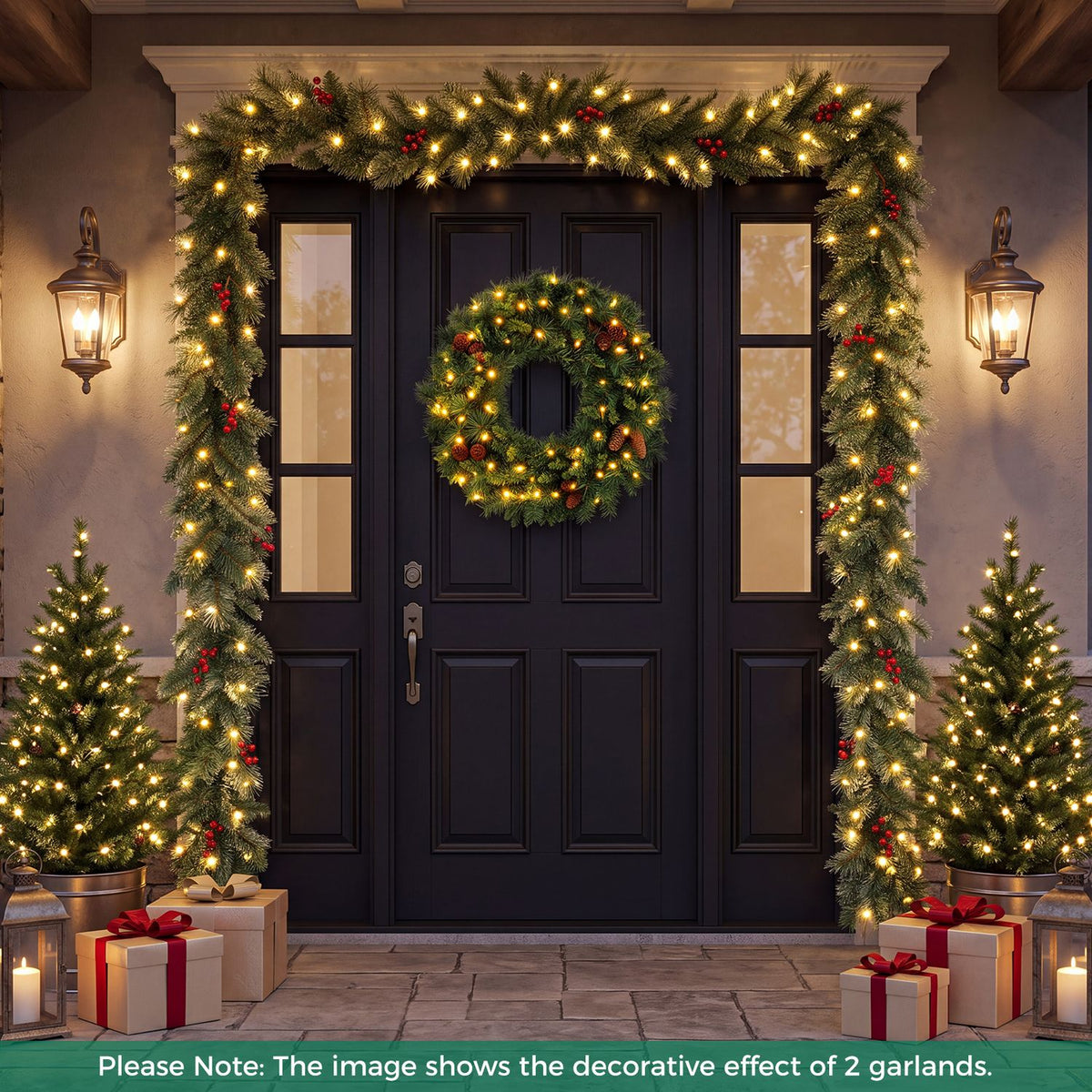 Lit greenery frames a dark front door, with a wreath, two small trees and wrapped gifts nearby.