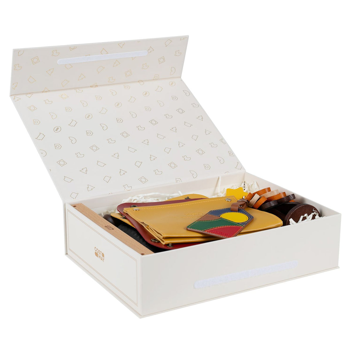 Open white gift box showing a yellow wallet, colorful tag and other gift set pieces inside.