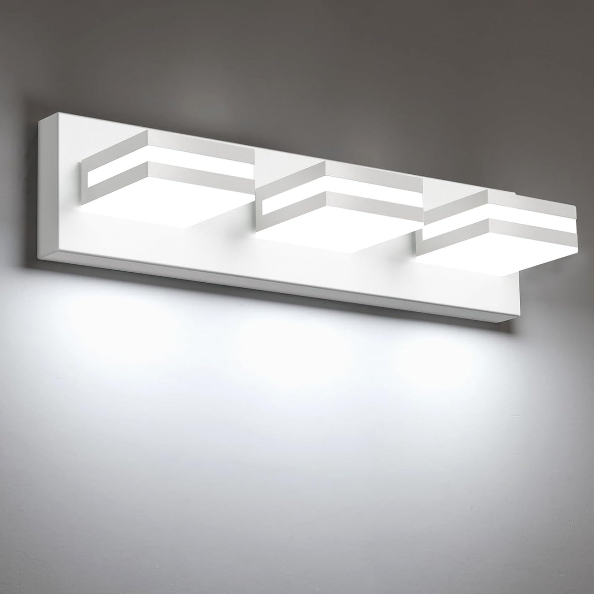 Close angled side view of a white finish vanity light showing three square LED modules and mounting plate.