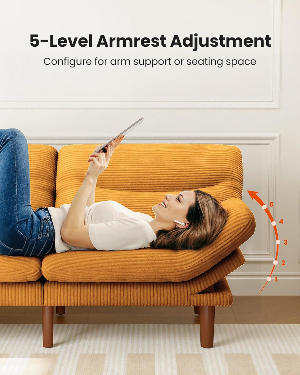 Person lying on the futon using a tablet, highlighting the adjustable armrest positions