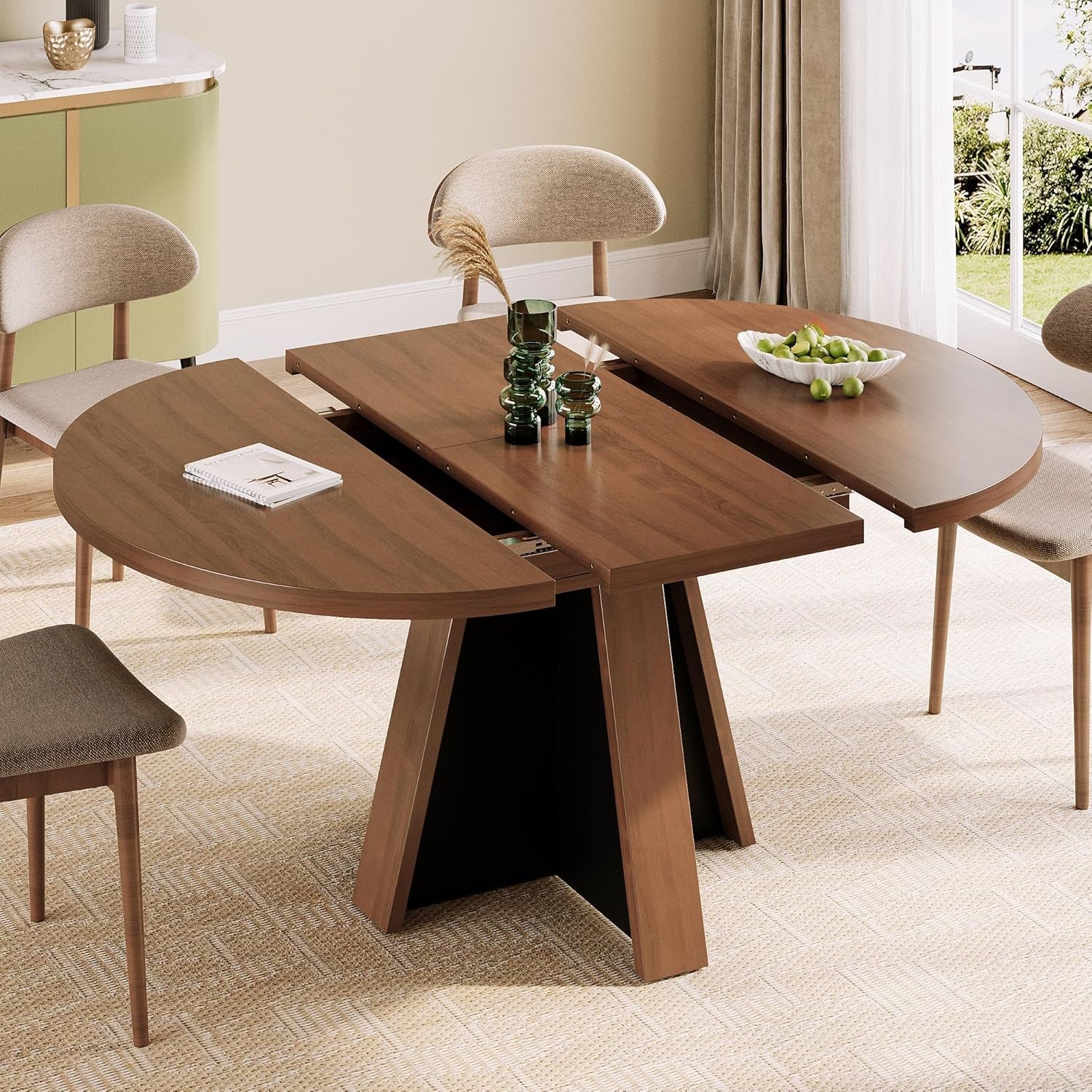 Round table pulled apart to reveal center extension leaf and storage area in the middle