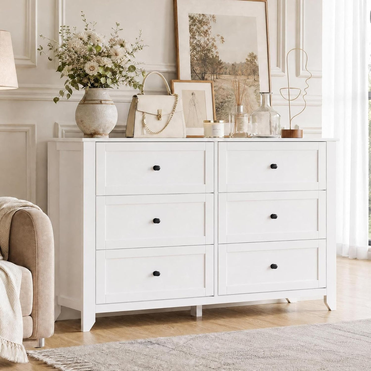 Close-up of white dresser top with decorative items and two upper drawers