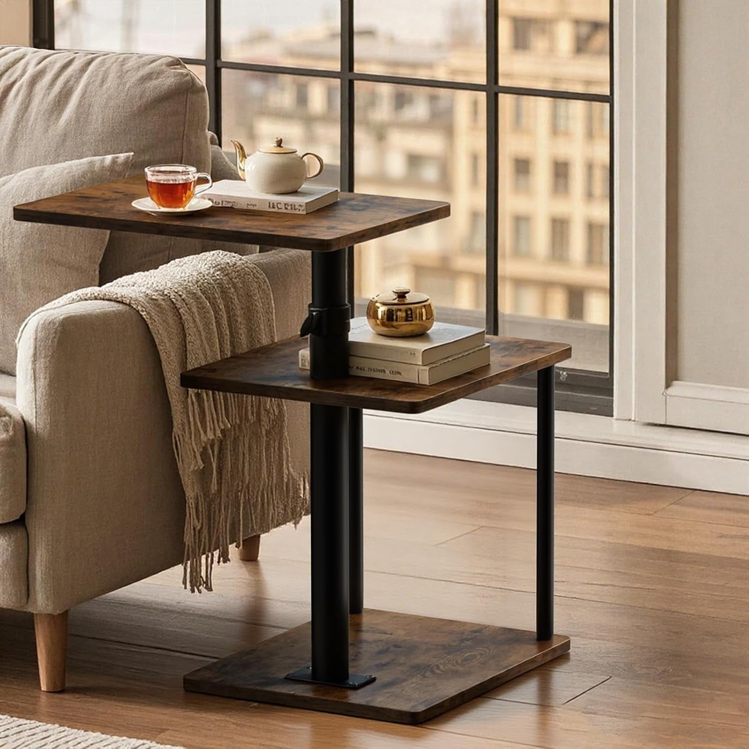 Three-tier C-shaped end table in rustic brown next to a beige sofa by a window.