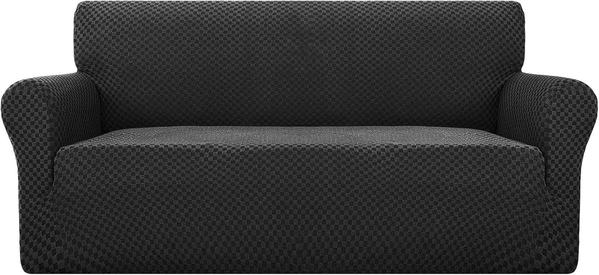 Straight-on studio shot of a dark charcoal textured slipcover fitted on a three-cushion sofa