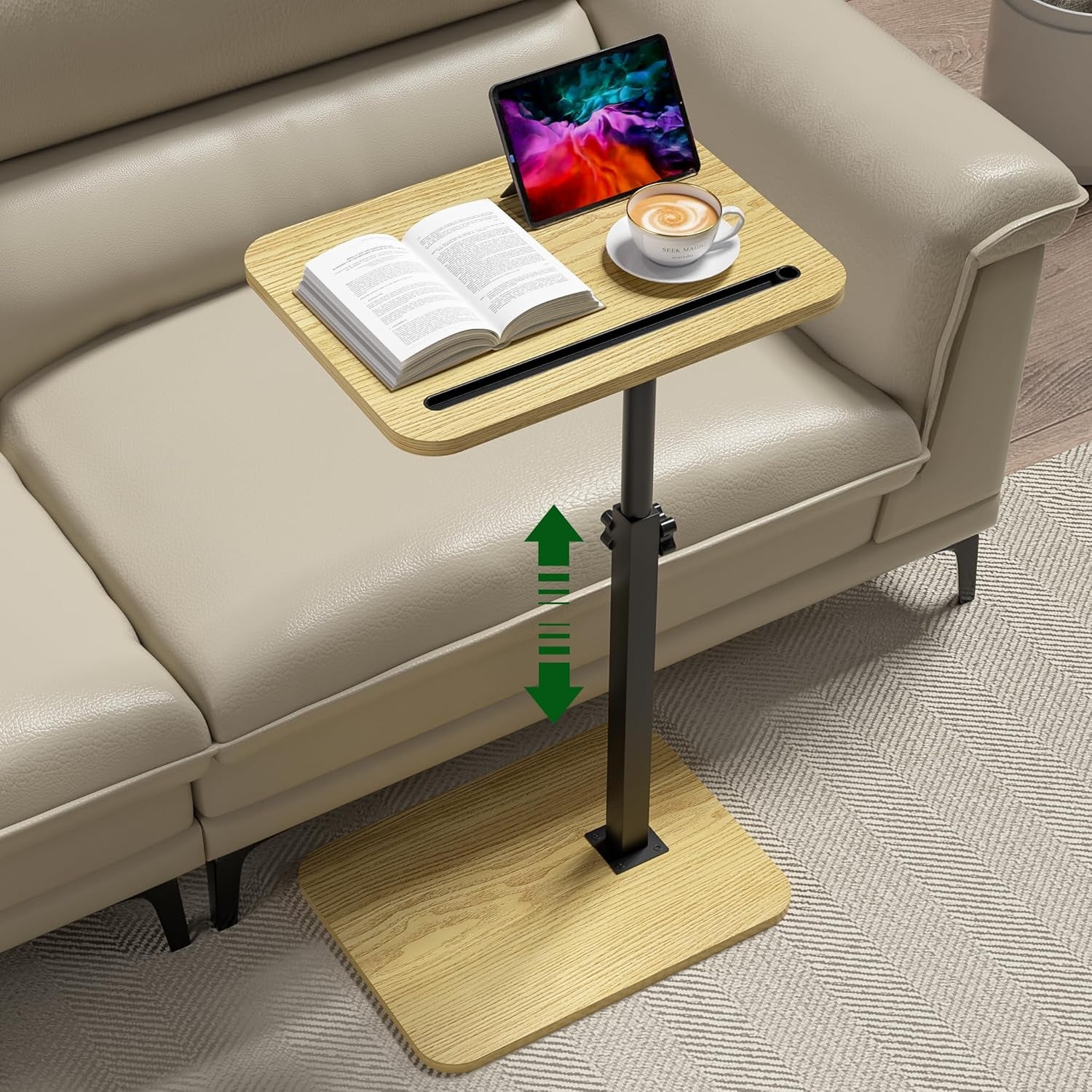 C-shaped side table with light wood top and base, black metal post, phone/tablet slot, book, tablet and coffee beside a
