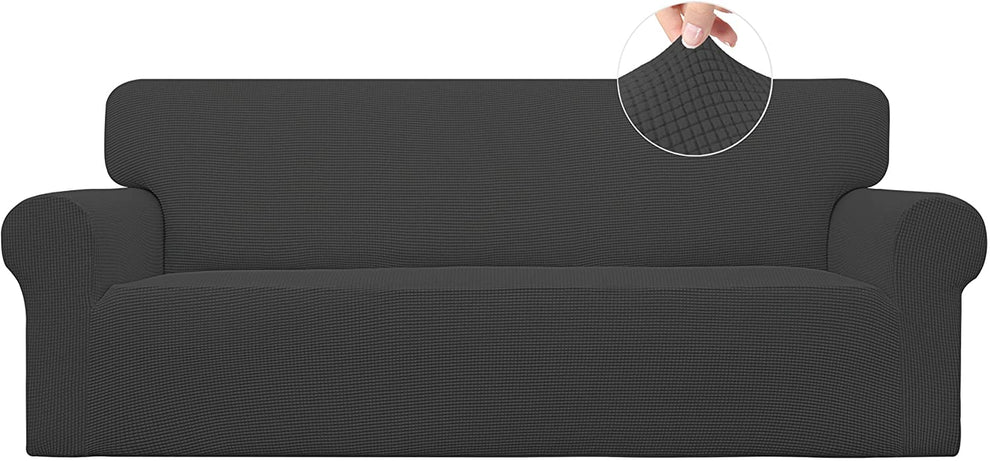 Front view of a dark gray covered sofa with an inset circle showing a hand stretching the textured fabric.