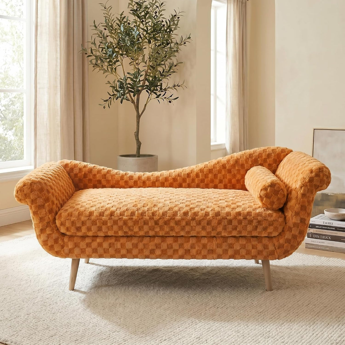 Right-facing burnt-orange chaise with textured checker upholstery and a matching cylindrical bolster pillow.