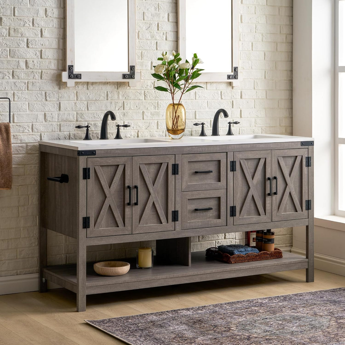 Frontal view of a double-sink gray farmhouse vanity with two faucets, central drawers and an open bottom shelf.