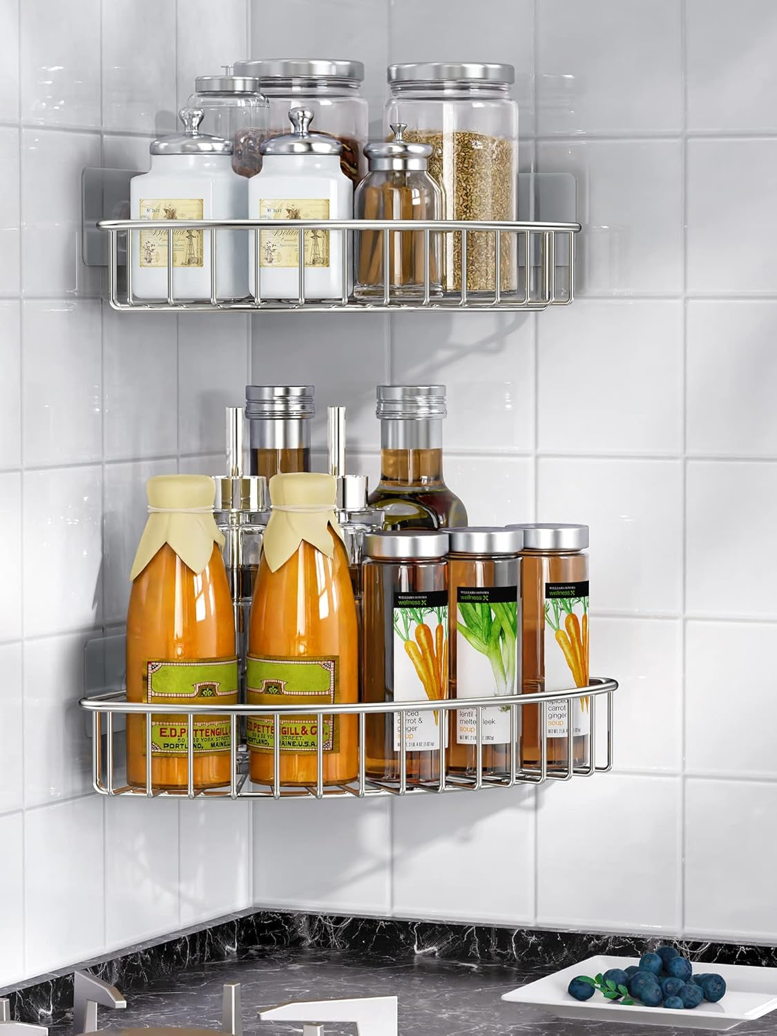 Silver corner shelf installed in a kitchen corner holding jars and bottles, angled lifestyle product shot