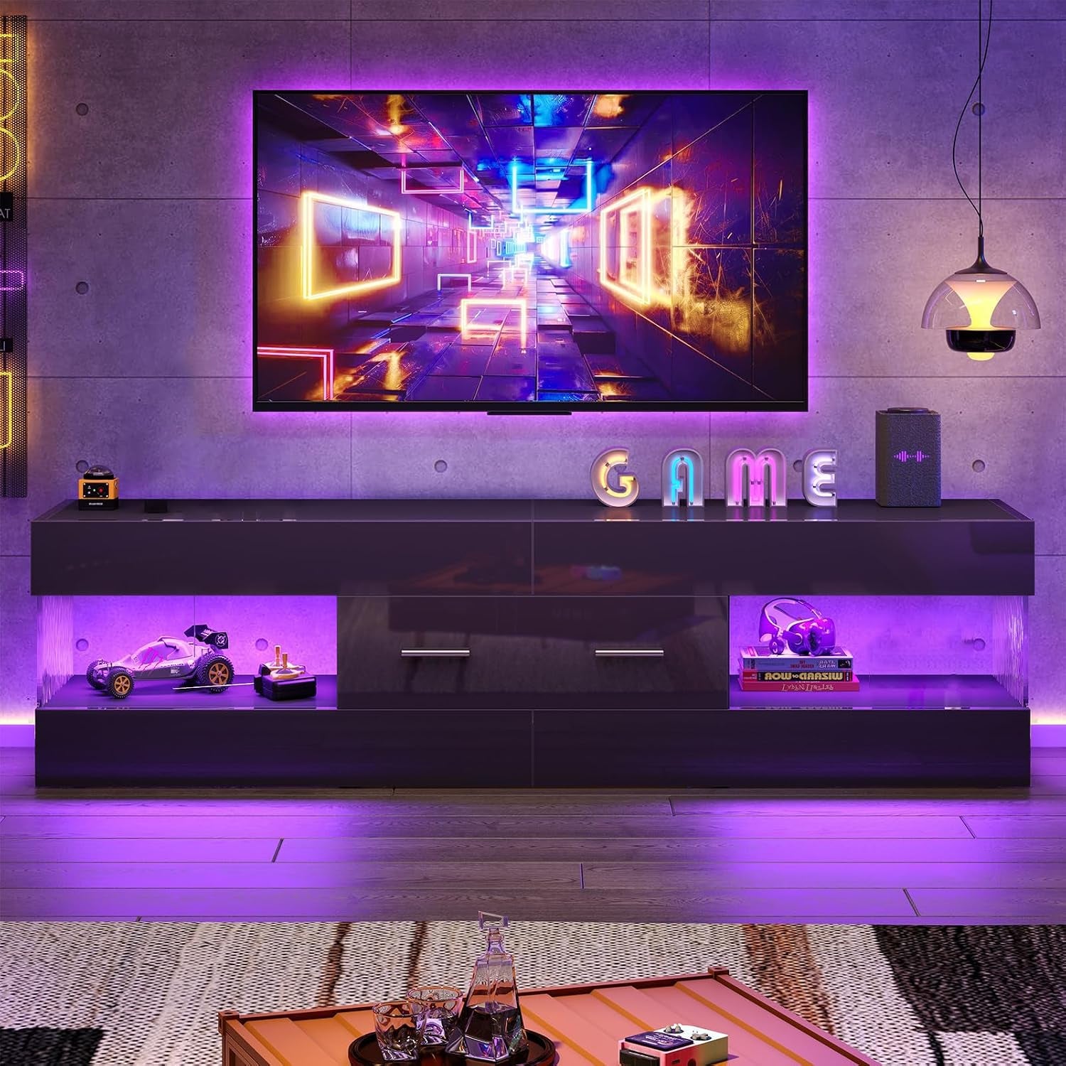 Black high-gloss TV stand with purple LED accent lighting shown in a game-themed room, front view