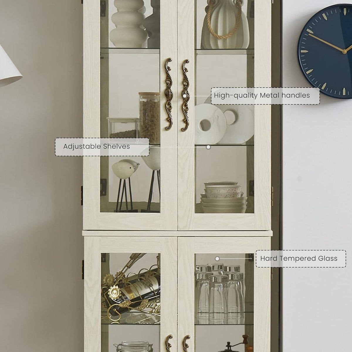 Close frontal crop showing the cabinet's upper and lower glass doors, ornate metal handles and interior shelves.