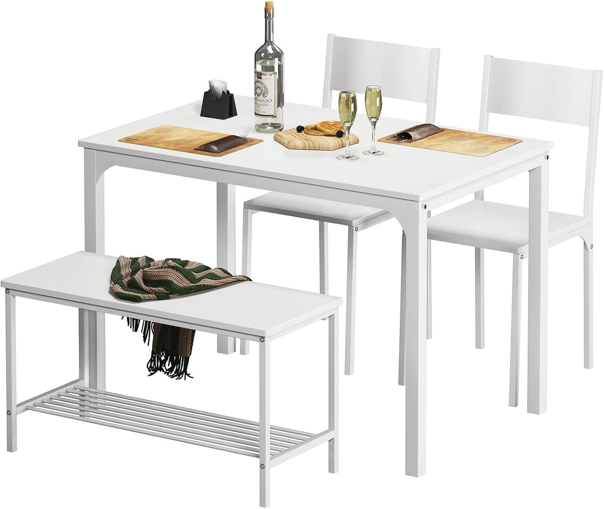 All-white dining table set shown with bench and two chairs, tabletop styled with bottle, glasses and place mats.