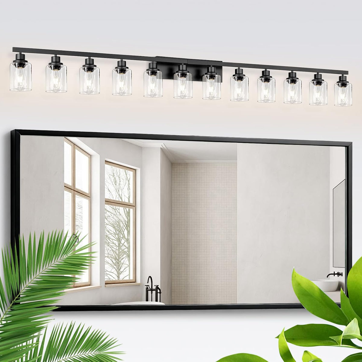 Black long vanity bar with ten lit clear glass shades installed above a wall mirror.
