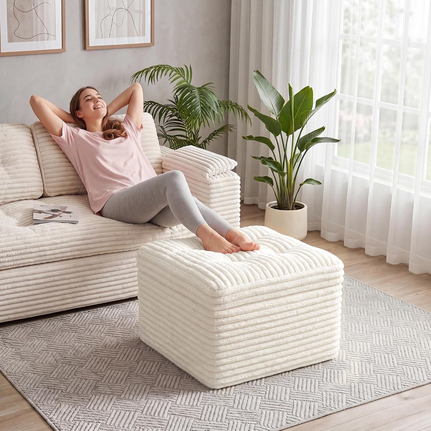 Relaxed woman leaning back on a matching beige corduroy sofa with pouf footstool in front.