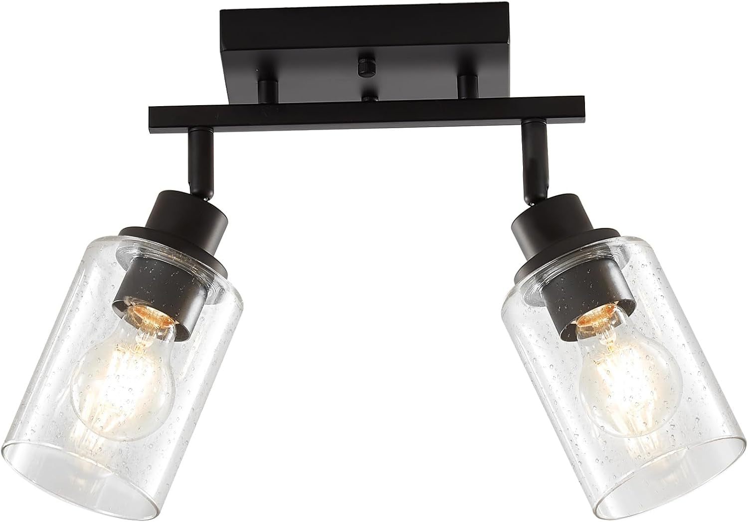 Low-angle close-up of two matte black seeded glass shades and square ceiling canopy, bulbs glowing inside shades