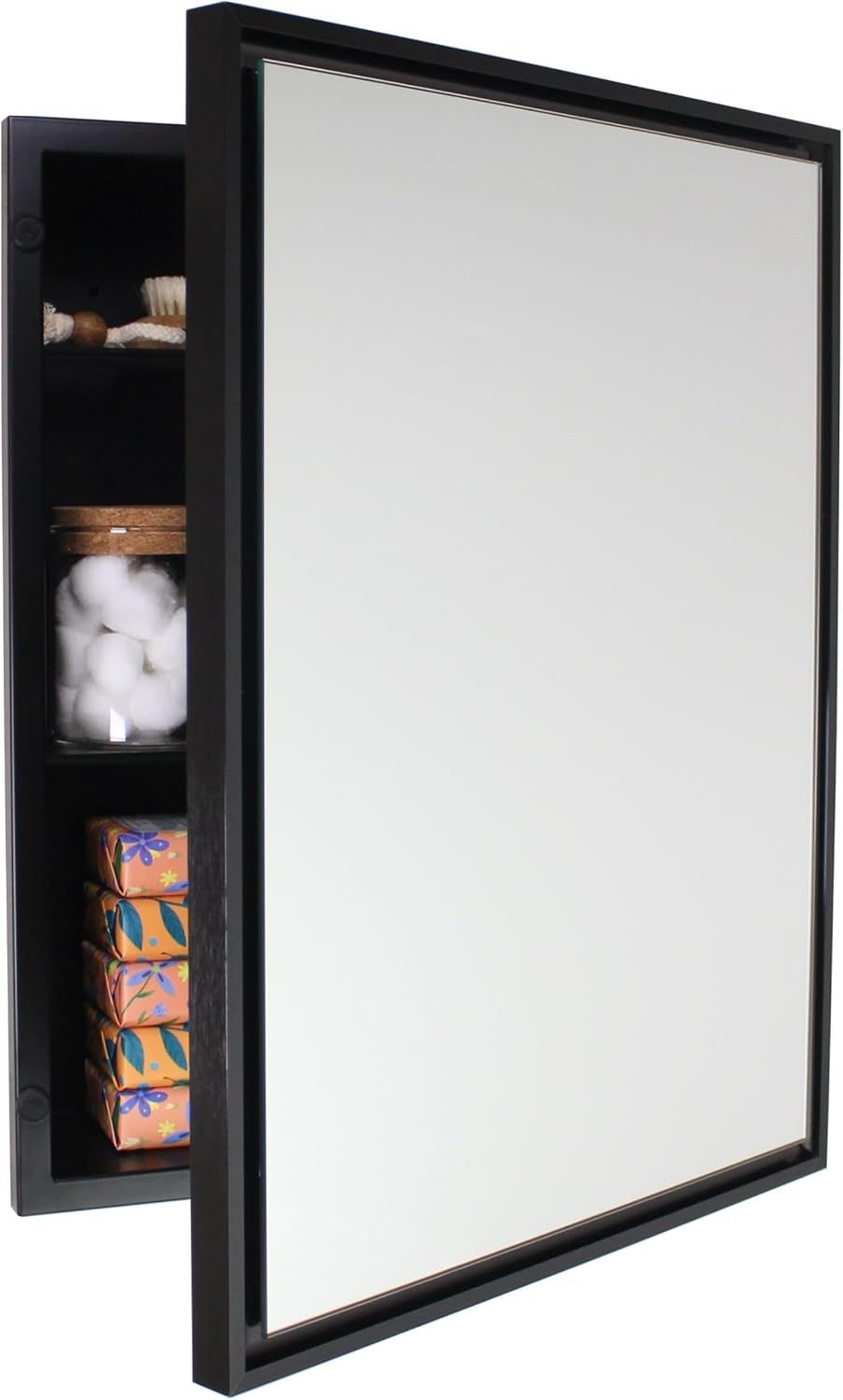 Black-framed recessed medicine cabinet with mirror door ajar revealing dark interior and stored cotton and soap boxes.