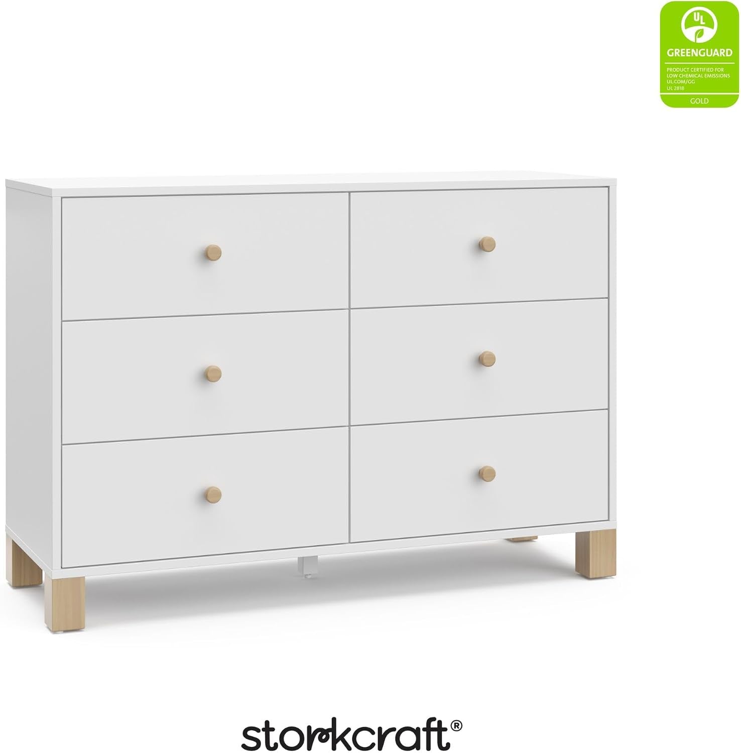 Three-quarter front view of a white six-drawer dresser with light wood knobs and square wood legs.