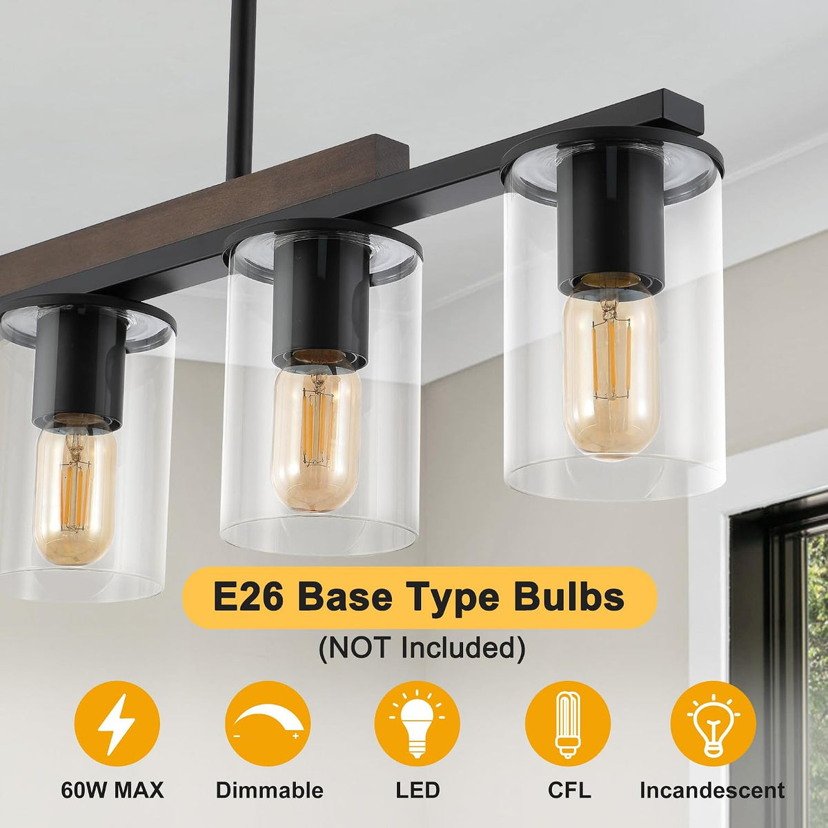 Close view of three clear glass cylinders and vintage-style bulbs hanging from black sockets.