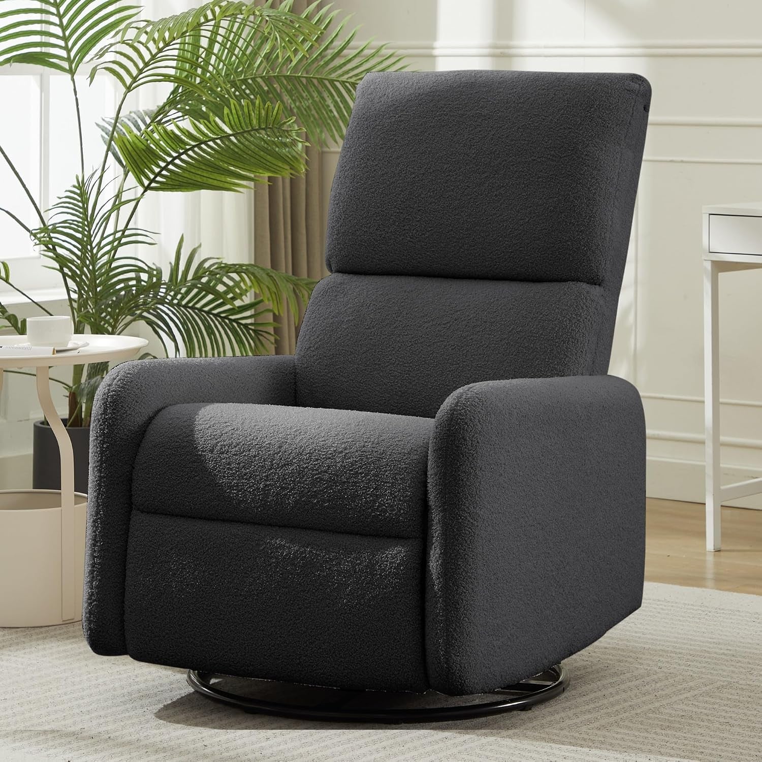 Dark gray sherpa glider chair with high back and black swivel base in a bright room