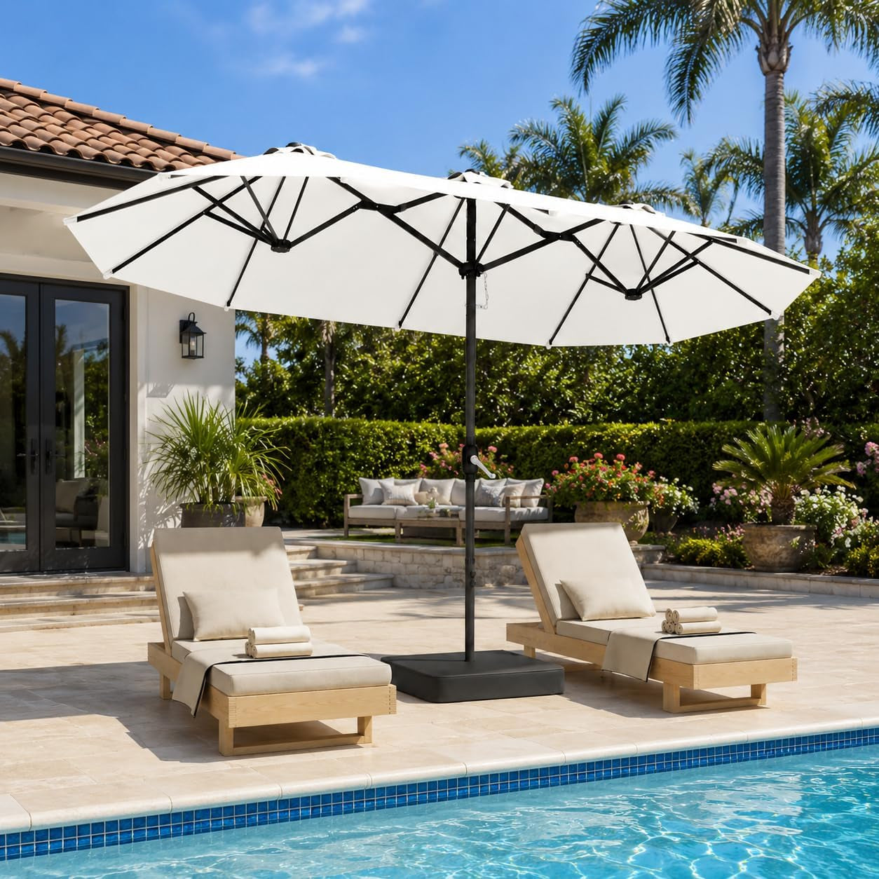Rectangular poolside umbrella shading two chaise lounges beside a swimming pool in a landscaped backyard.