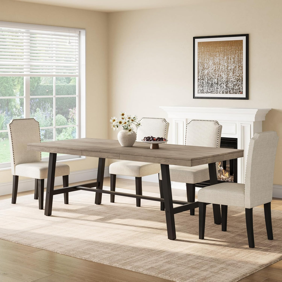 Rectangular dining table with light gray wood top and black metal legs in a sunlit dining room