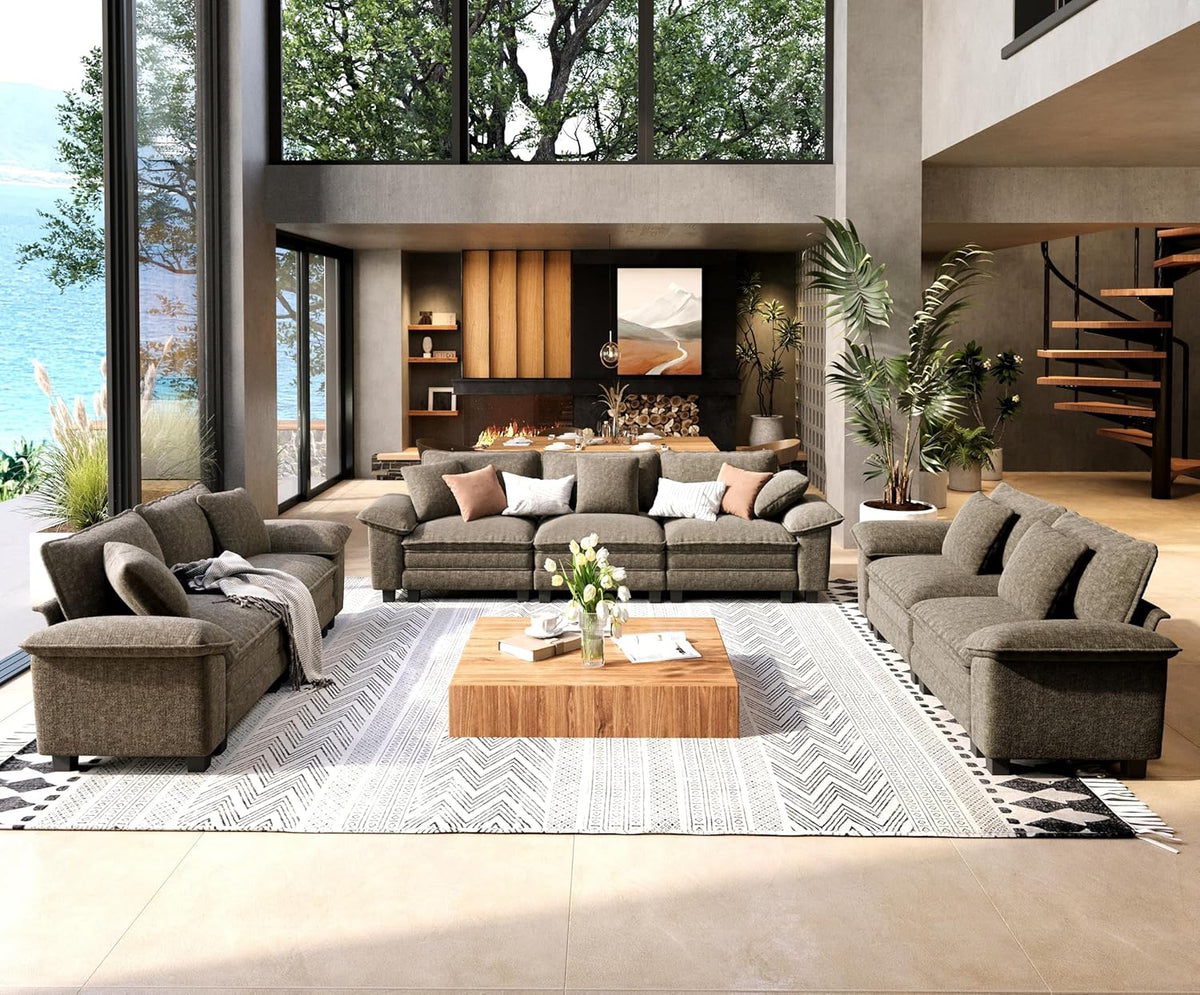 Wide view of a living room with a dark brown sofa set arranged around a low wooden coffee table on a large rug.