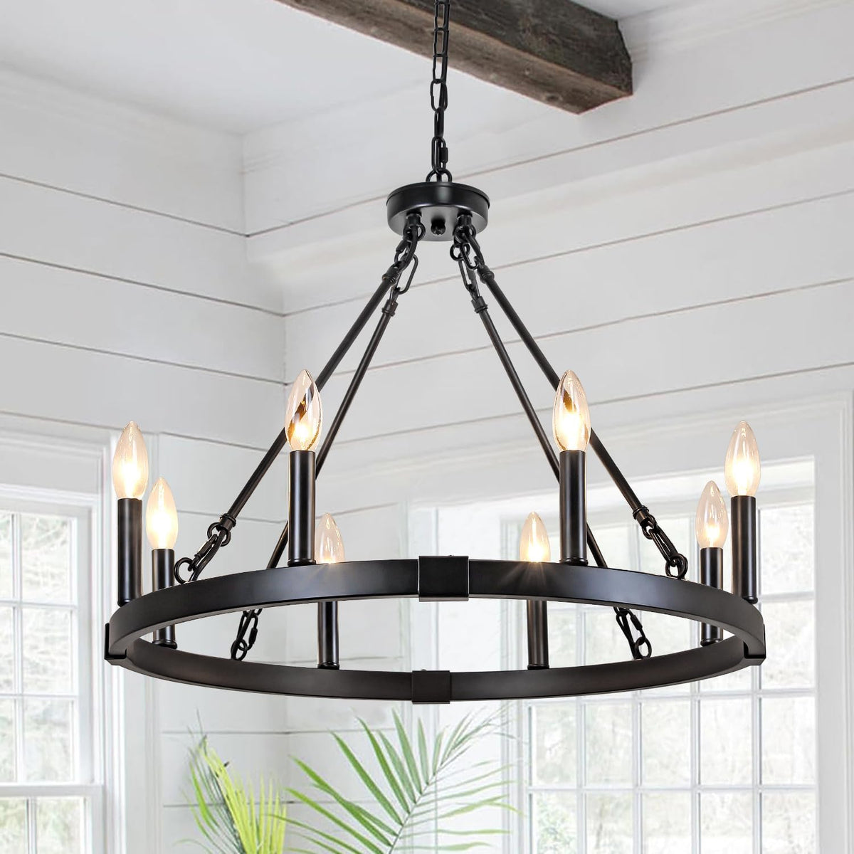 Black metal ring chandelier viewed from above showing chains, angled support rods and candle-style lights.