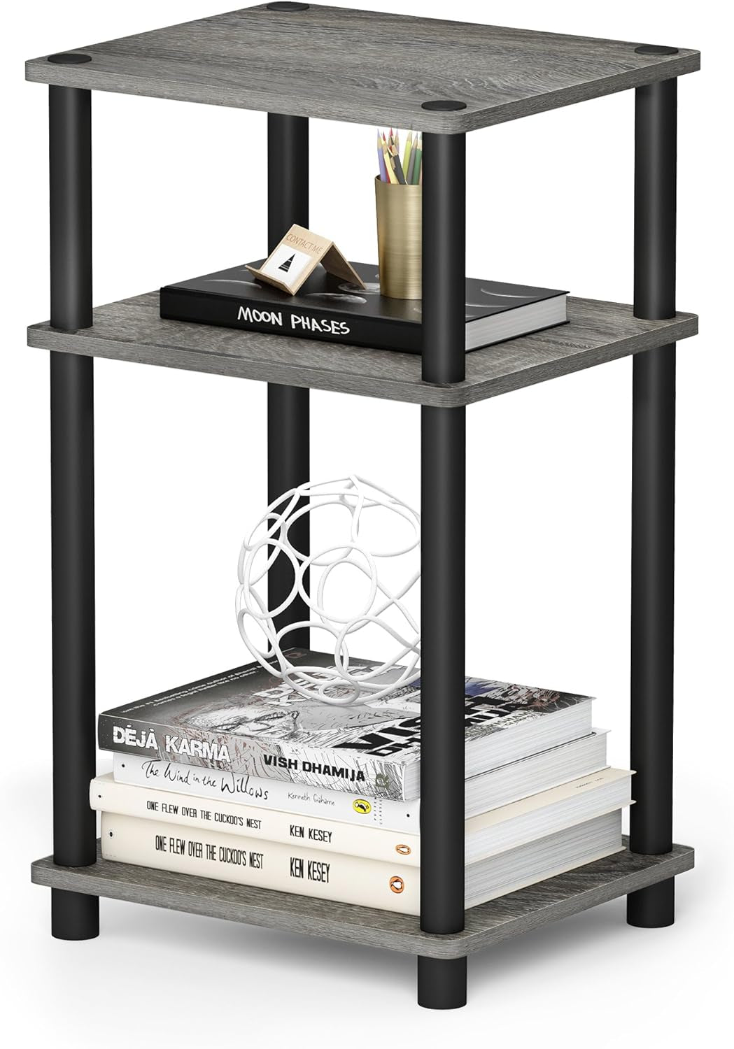 Three-tier open shelf end table with gray wood shelves and black round legs, books and decor on shelves