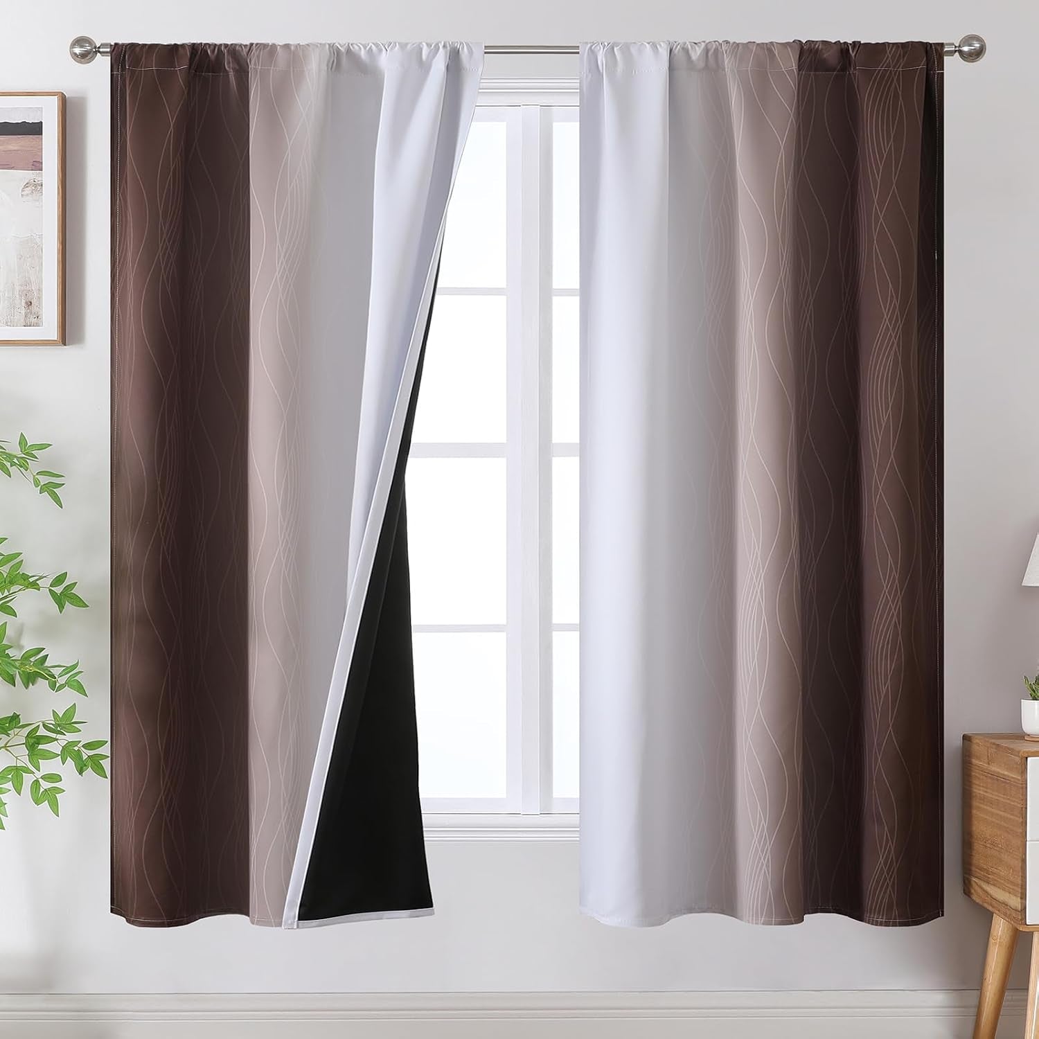 Window dressed with brown-to-white gradient curtains with subtle wavy line pattern and a black blackout inner lining.