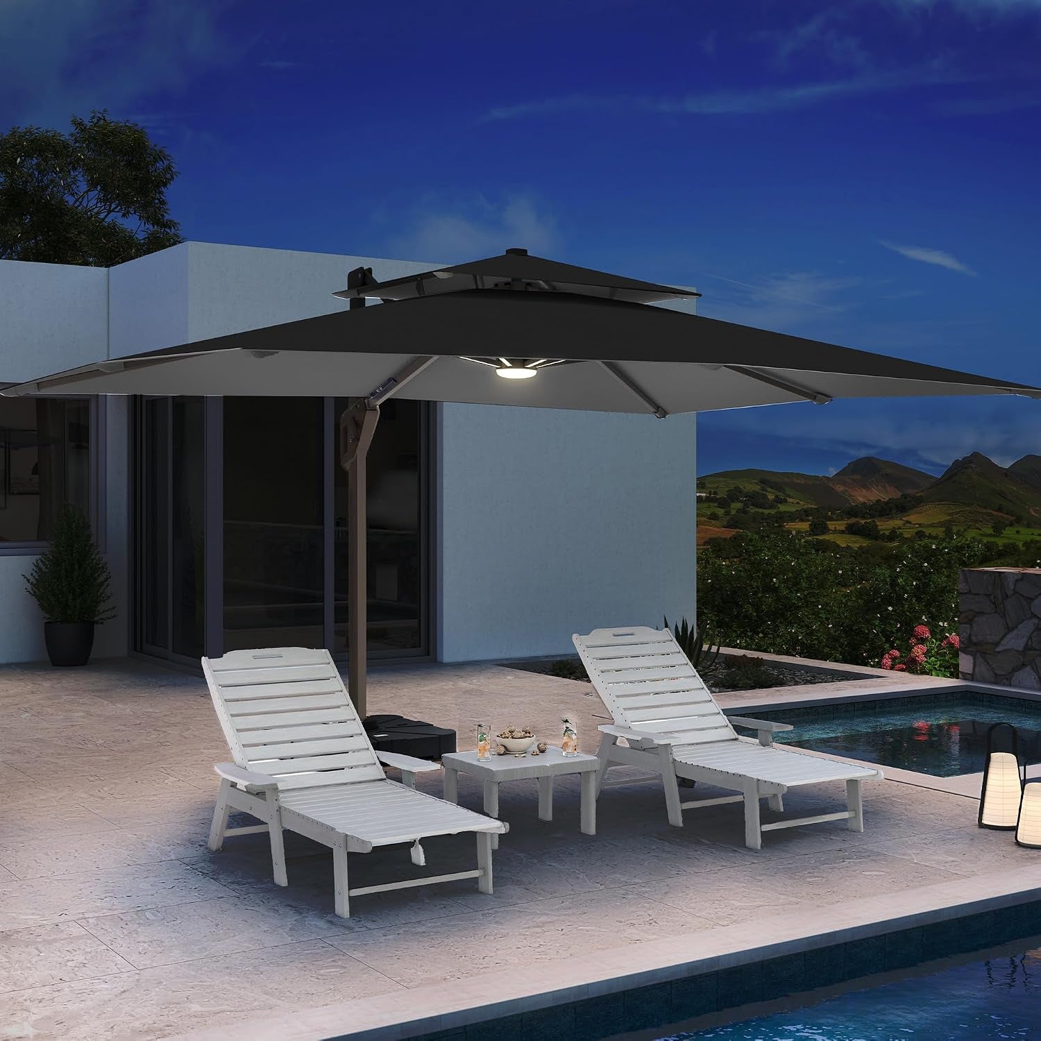 Nighttime view of open umbrella over two white pool loungers with LED light glowing under canopy.