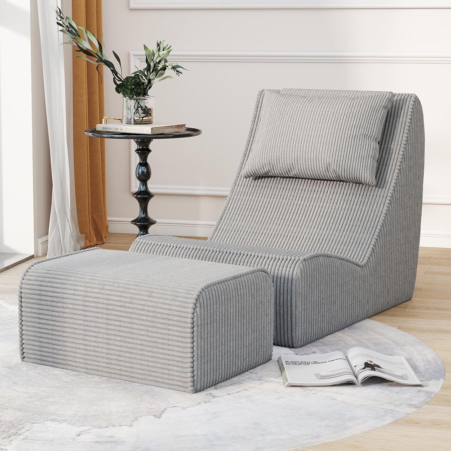 Light gray ribbed-texture chaise lounge with ottoman, front-right view on a round rug