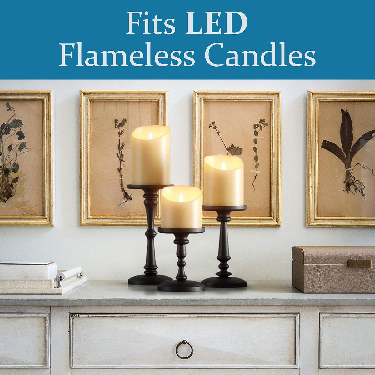 Matte black candle holders on a console table under framed botanical art with a Fits LED Flameless Candles banner