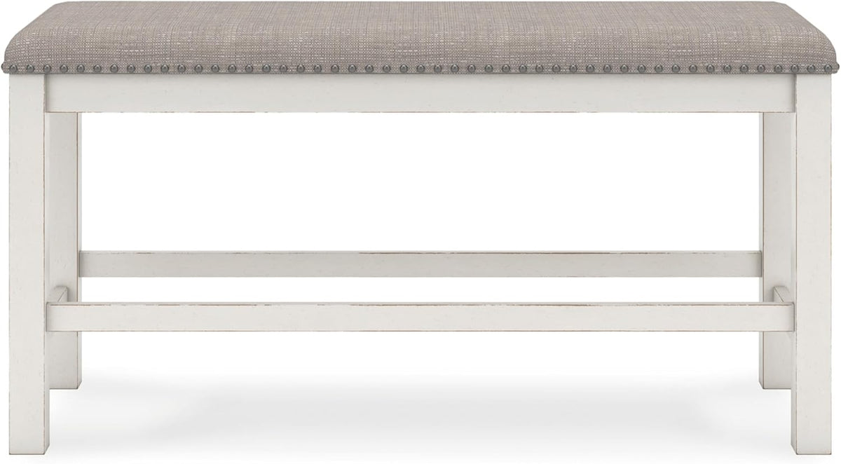 Front-facing bench with distressed white wooden frame and gray upholstered seat with nailhead trim.