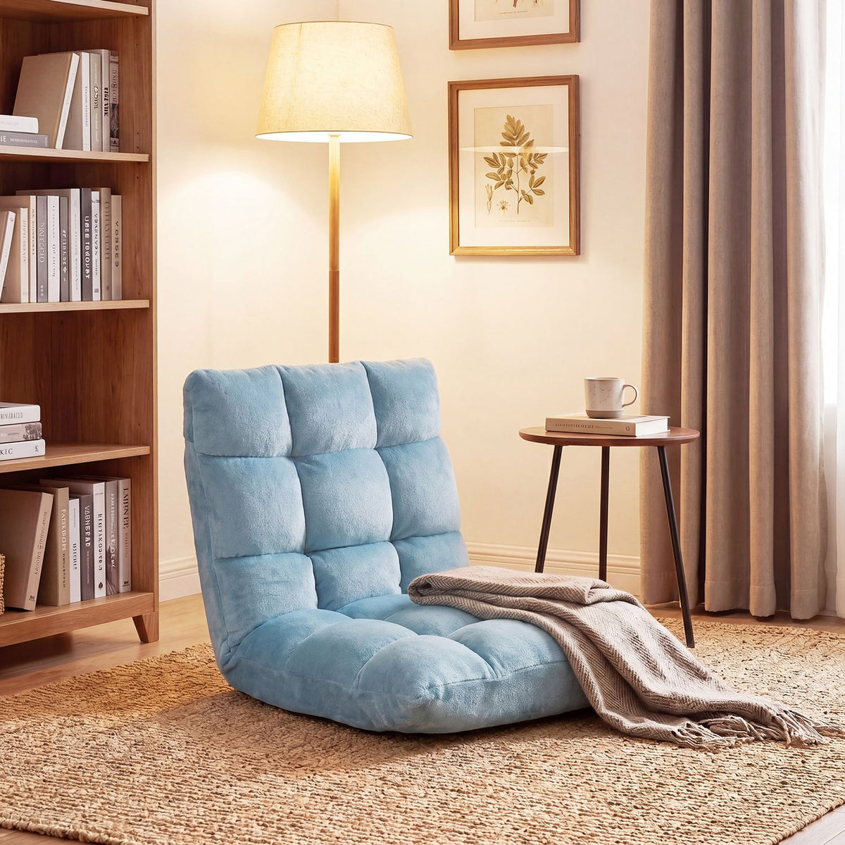 Blue cushioned floor chair beside a bookshelf and side table in a warmly lit living room.