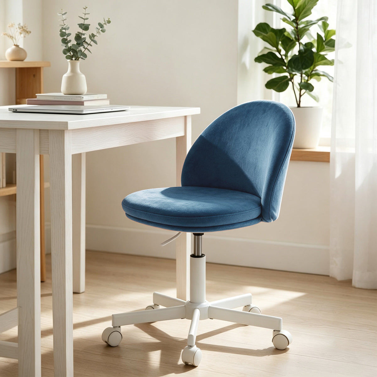 Blue upholstered vanity chair with a curved back and white wheeled base beside a desk.