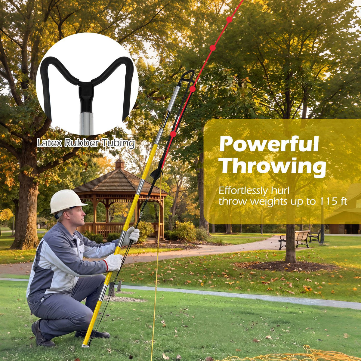A worker kneels on a lawn and aims the long pole launcher upward toward a tree.