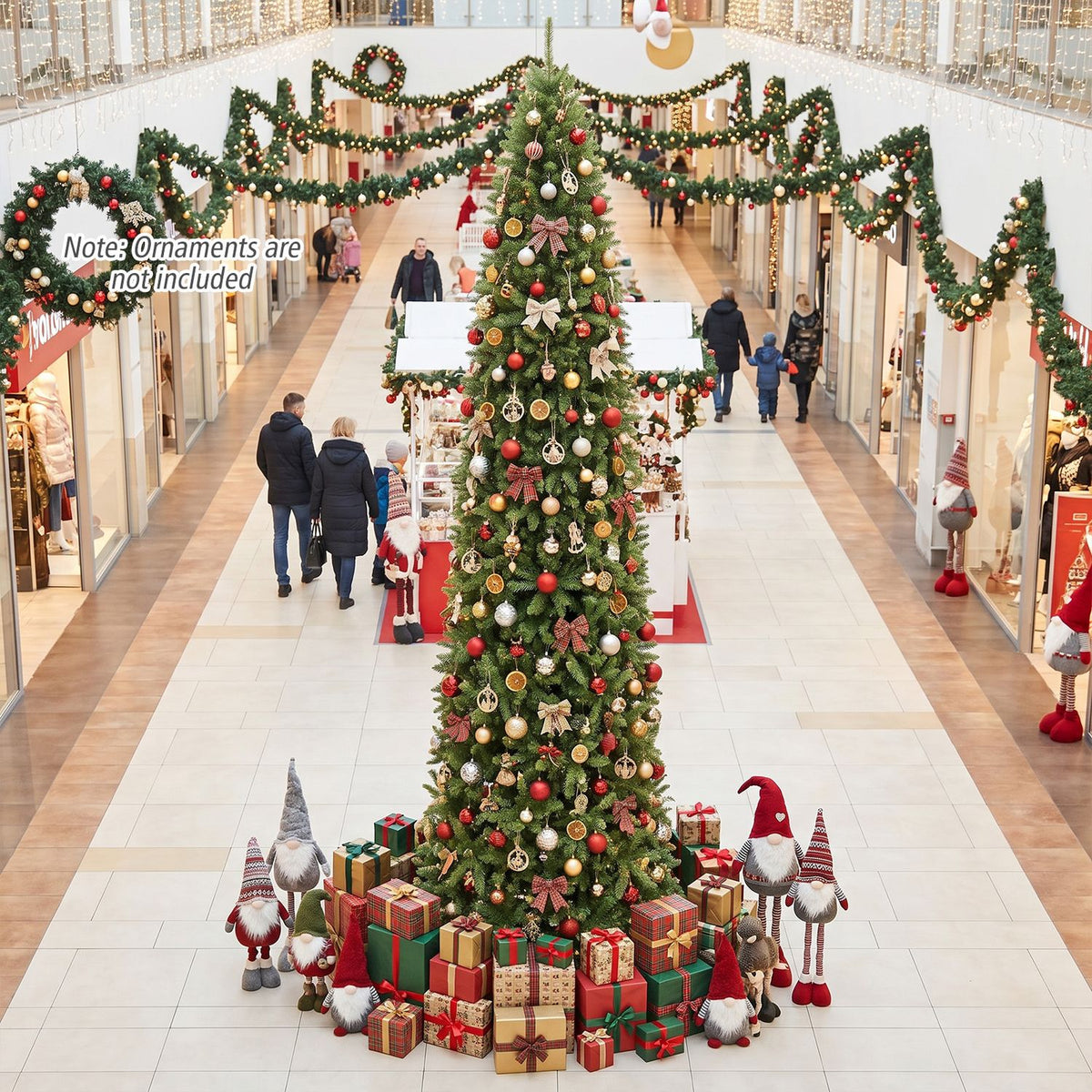 Decorated Christmas tree displayed in a shopping mall, surrounded by wrapped gifts and holiday figures.
