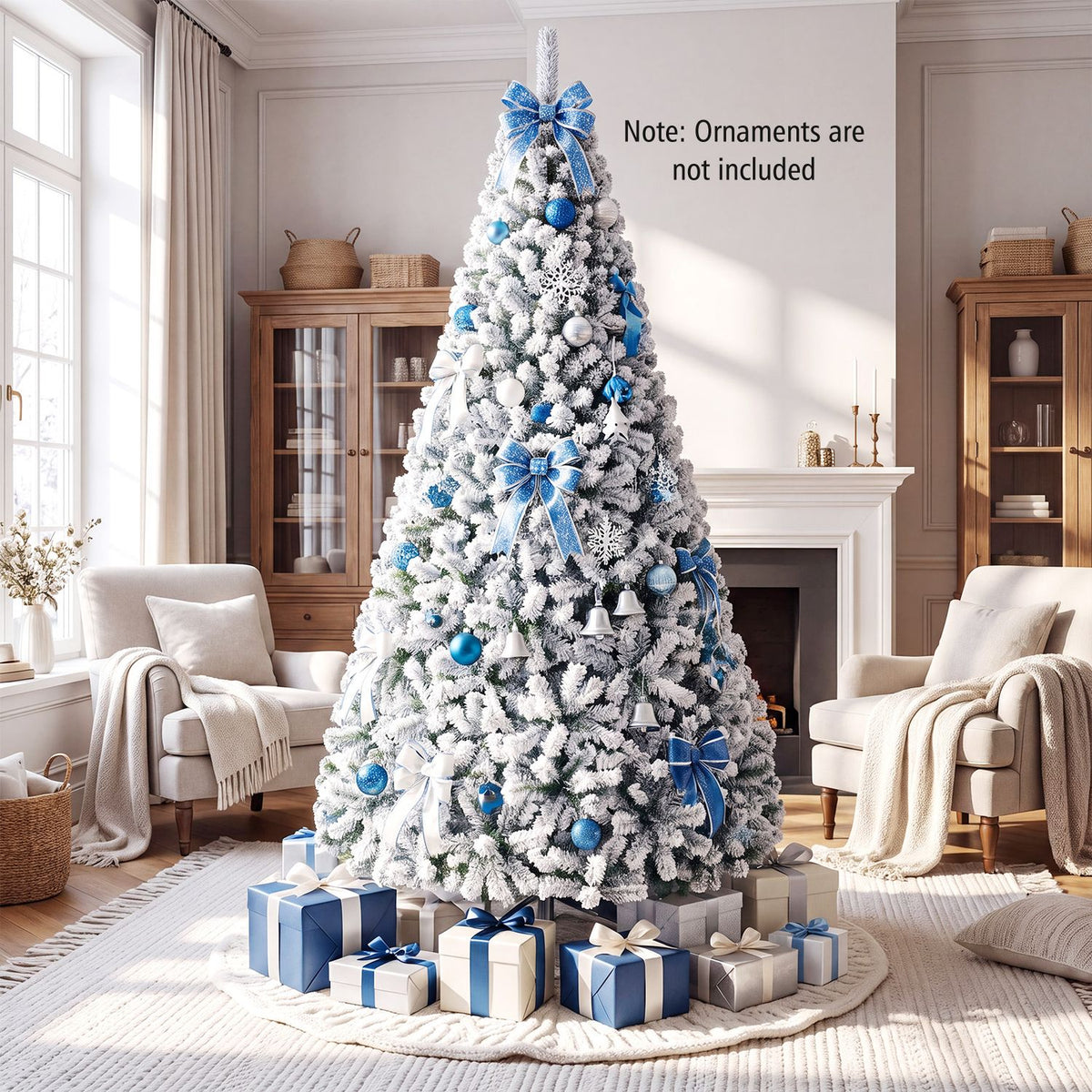 A snowy Christmas tree decorated with blue bows and ornaments stands before a fireplace with gifts below.