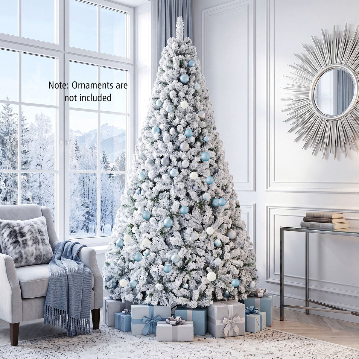 Snow-flocked tree decorated with blue and white ornaments, surrounded by wrapped gifts in a bright living room.