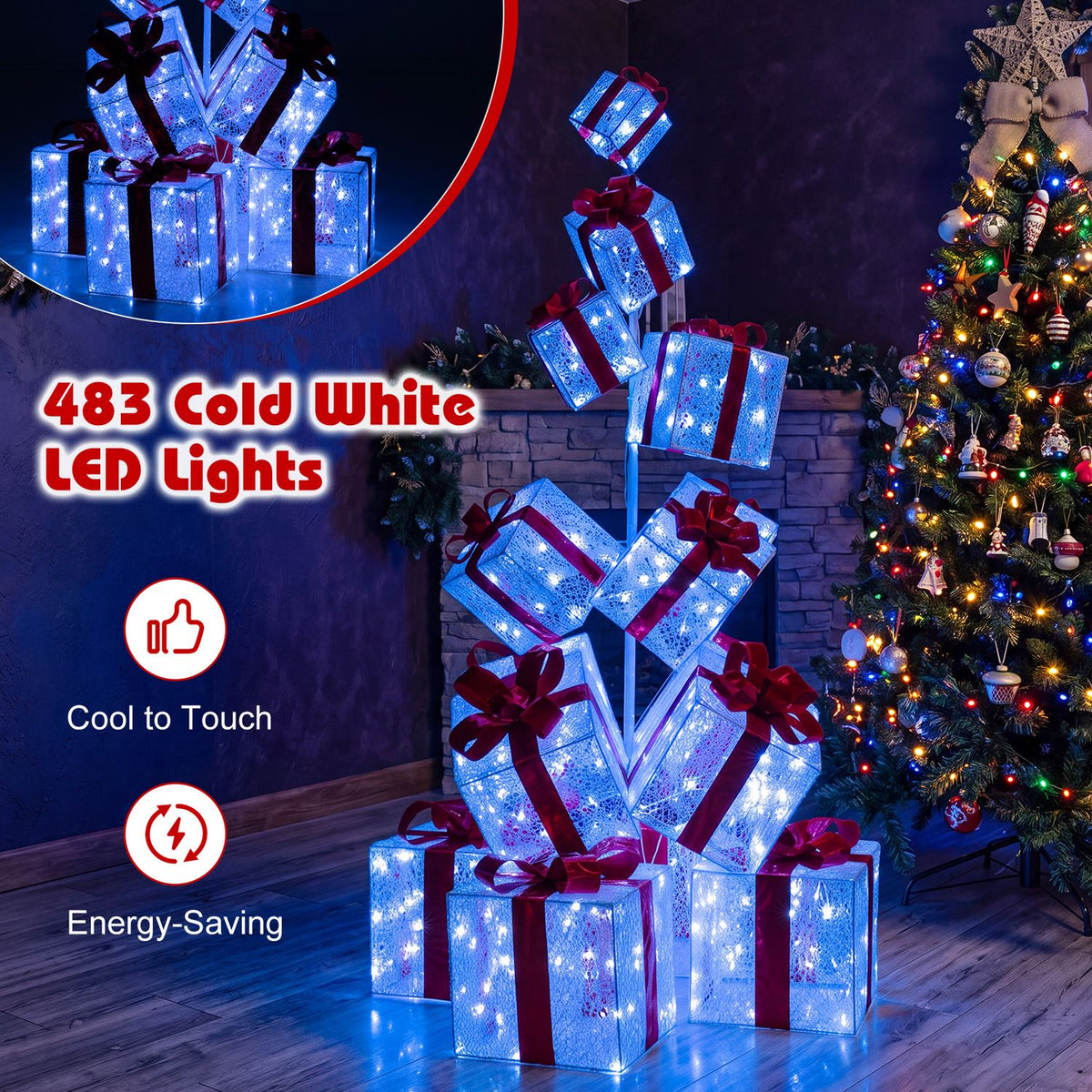 Blue-white illuminated gift boxes stacked beside a decorated Christmas tree in a dim room.