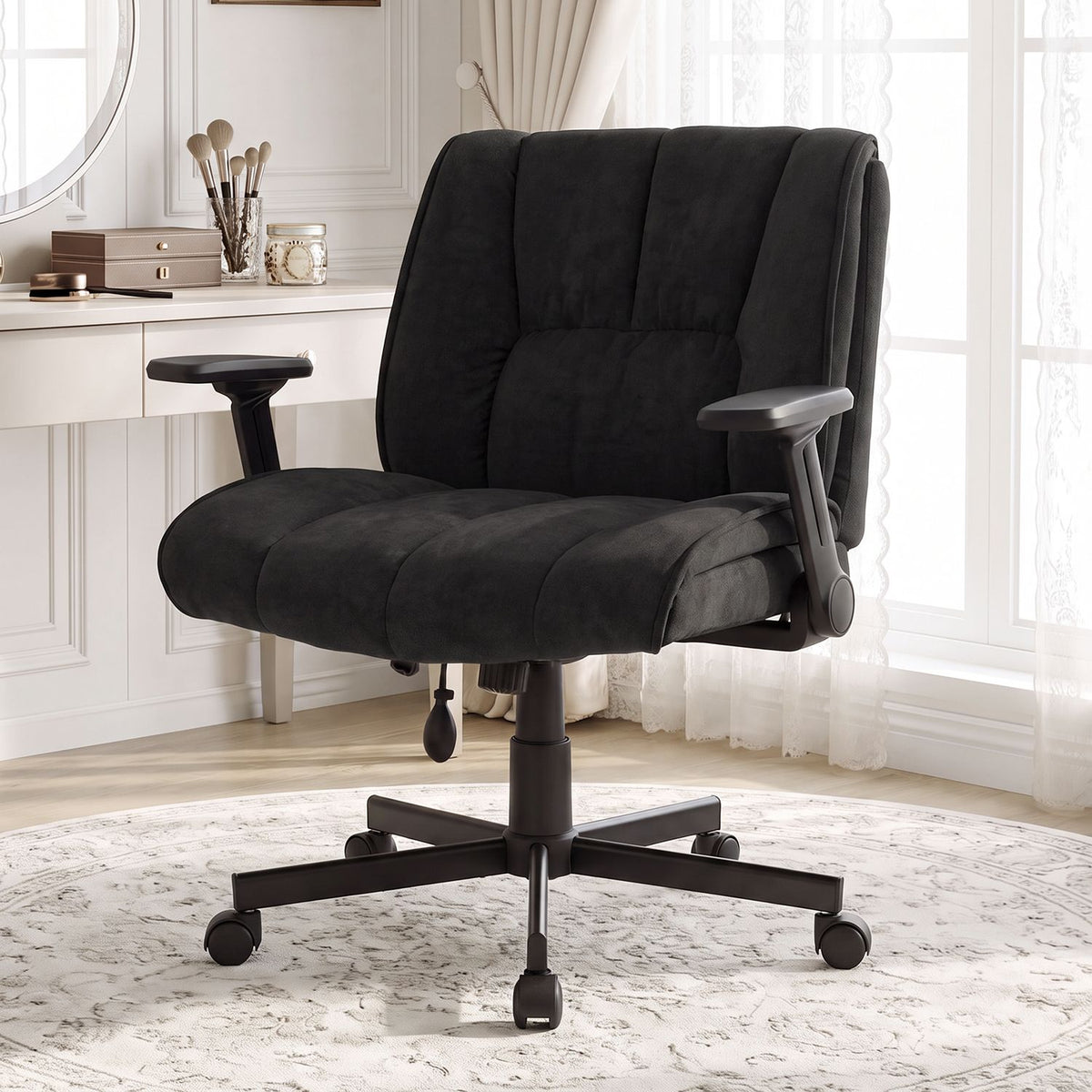 Black padded office chair facing forward in a sunlit room