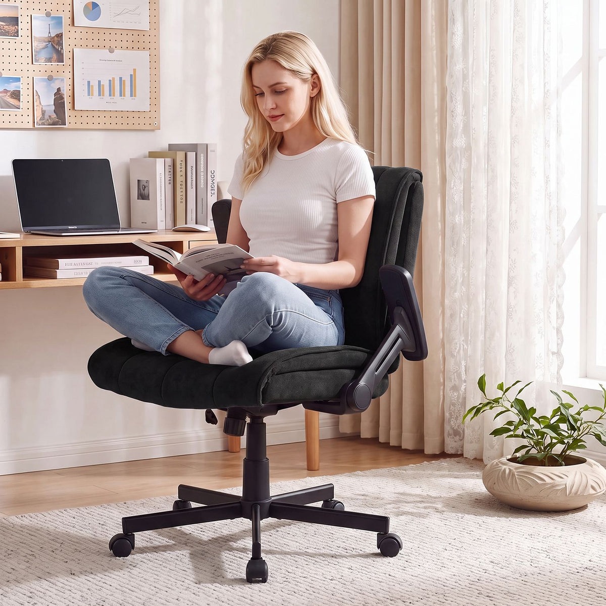 Woman seated on a black office chair reading in a home office