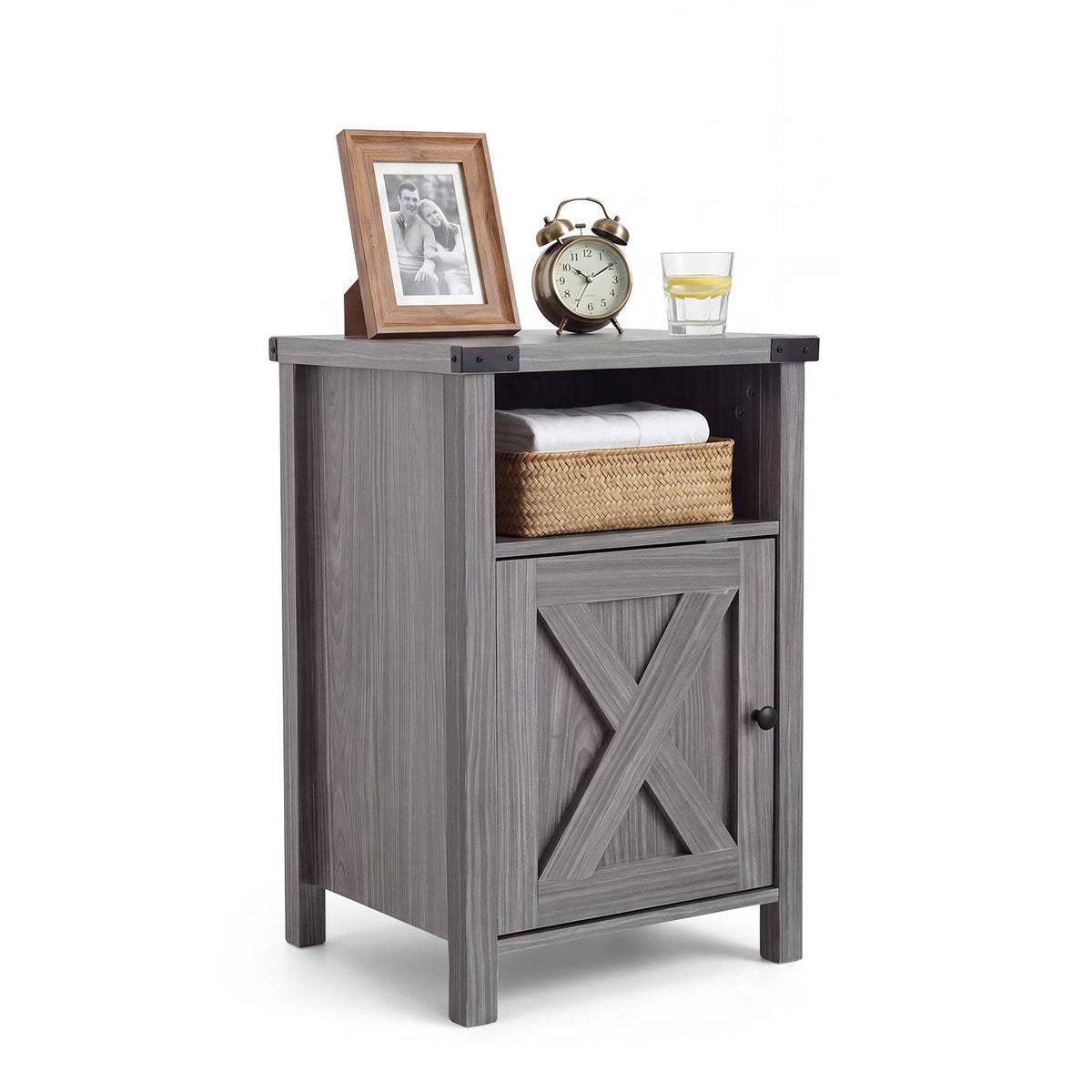 Gray farmhouse nightstand on white with a basket in the open shelf and framed photo on top.